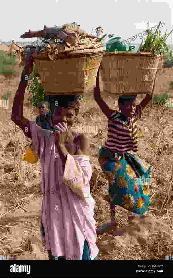 A Group Of African Women Carrying Baskets Of Goods On Their Heads, Walking Through A Street In Colonial Lagos. Livelihood In Colonial Lagos M Hakan Yavuz